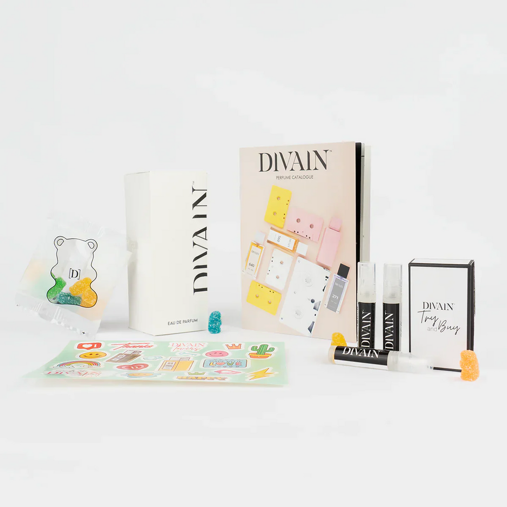 Opened divain package containing divain-608 perfume, stickers, and gummy candies
