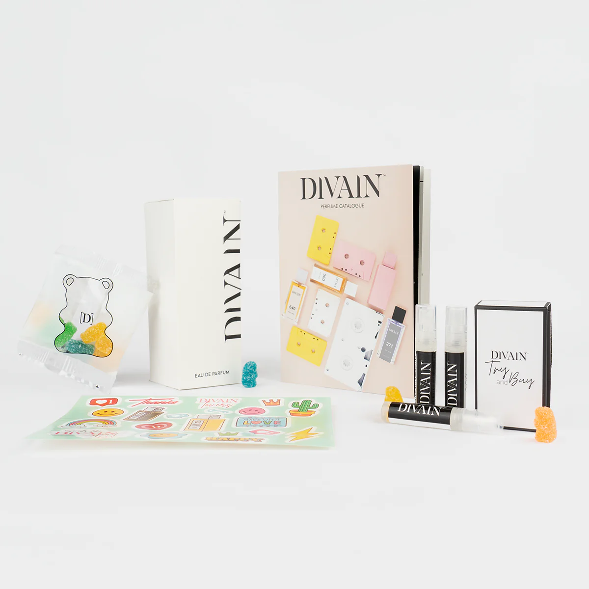 Opened divain package containing divain-976 alcohol-free perfume, stickers, and gummy candies